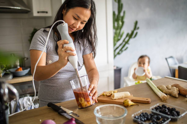 Making healthy fruits meal for baby Asian mother making healthy fruits meal for baby baby food stock pictures, royalty-free photos & images