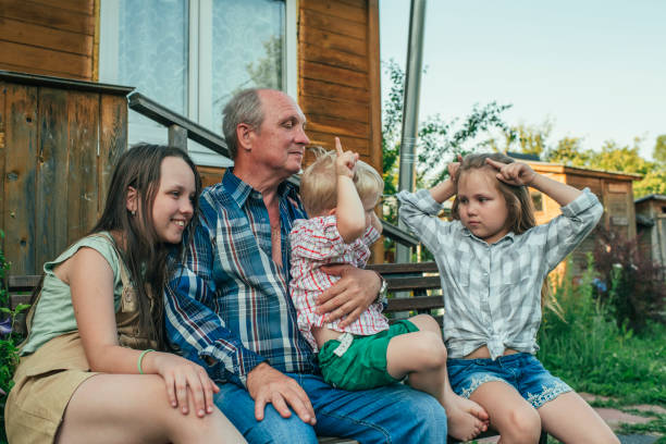 istock Children with grandfather in back yard in summer 1161663339