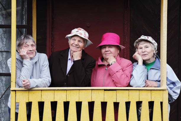 Four Russian elderly women are standing on the porch of their home Four Russian elderly women are standing on the porch of their home. Close friends. Friendship for life. Country life. slavic culture photos stock pictures, royalty-free photos & images