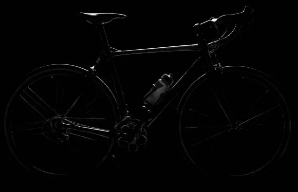Road bike. 
Low-key lighting. 
Isolated on a pure black background.