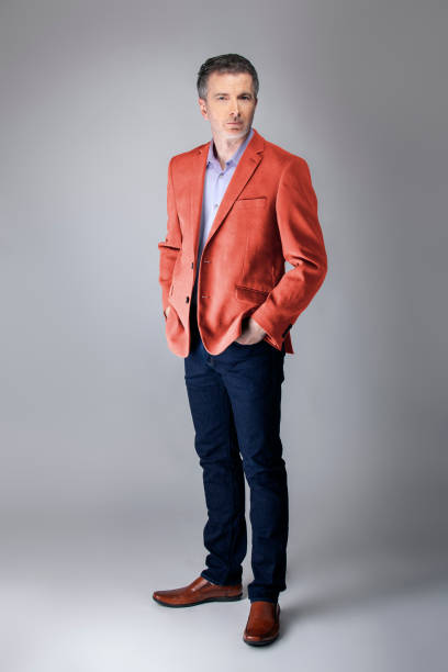 istock Stylish Middle-aged Model Wearing Coral Color Jacket 1161671169