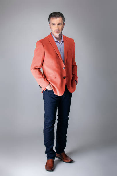 istock Stylish Middle-aged Model Wearing Coral Color Jacket 1161671190