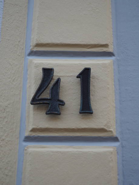 istock House number 41, black numbers on a cream-colored wall 1161673002