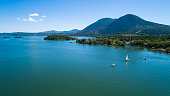 The aerial low-altitude scenic view of the Buckingham Park on the Clear Lake, California, with yachts on a moorage. The sunny spring day.