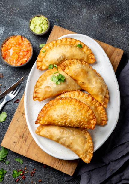 istock Latin American fried empanadas with tomato and avocado sauces. Top view 1161677006