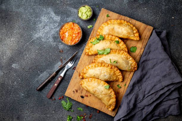 istock Latin American fried empanadas with tomato and avocado sauces. Top view 1161677007