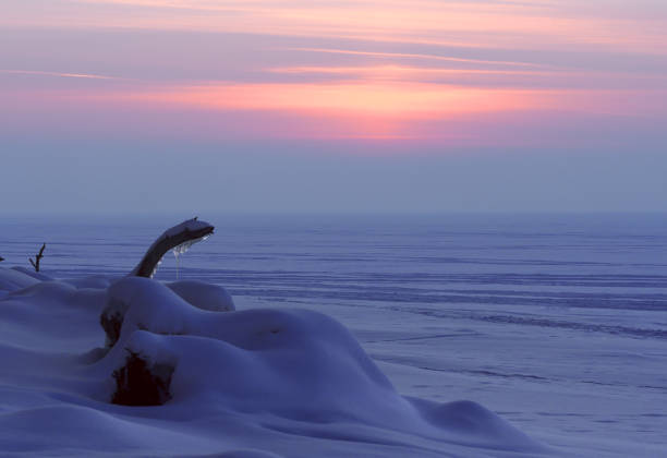 istock Pink purple winter sunset over a river 1161679532