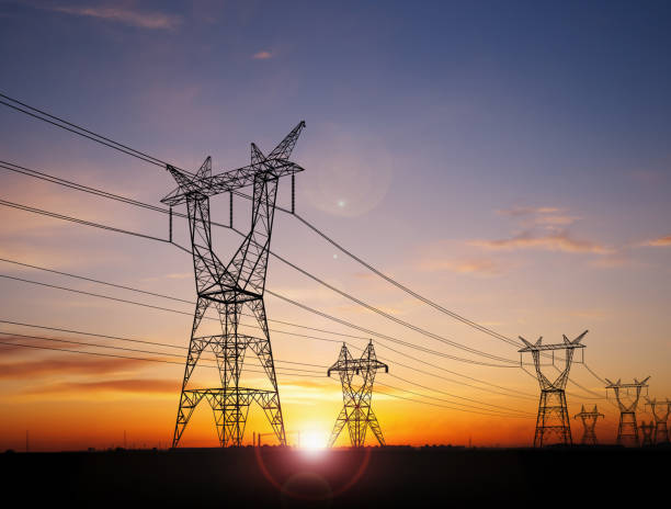 Electricity power pylons Electricity power pylons over sunset electricity stock pictures, royalty-free photos & images