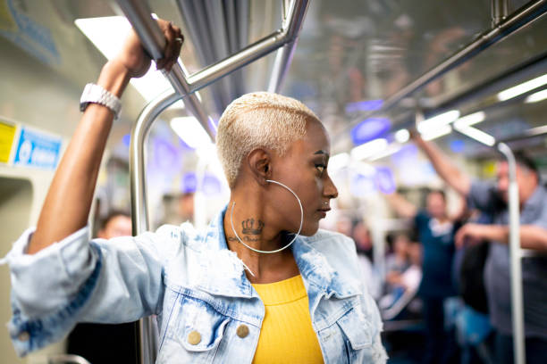 istock Profile view of a woman standing in a subway train 1161681682