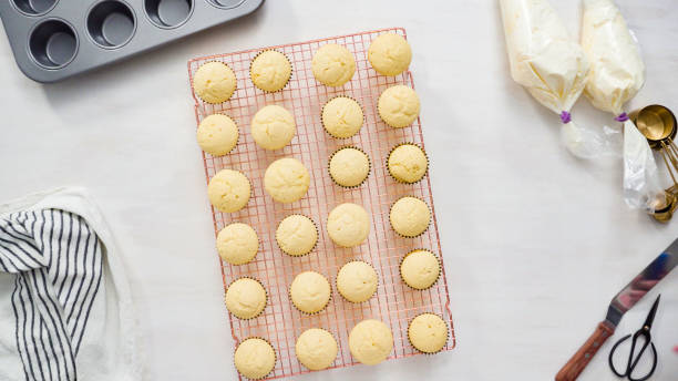 istock Cooling freshly baked vanilla cupcakes on a cooling rack. 1161686312