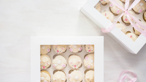 istock Boxing vanilla cupcakes in shape of Easter bunnies. 1161686371