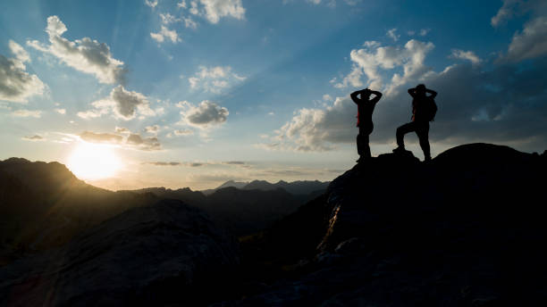 istock successful people looking proudly at the mountains 1161692798