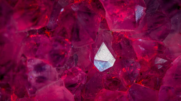 istock Isolated close up macro of an amethyst crystal lite in blue light 1161698551