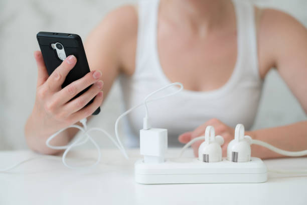 istock Woman using and charging a smartphone. Energy for life 1161698618