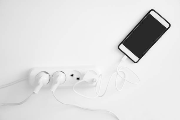 istock Charging a smartphone on white table. Energy for life 1161698622