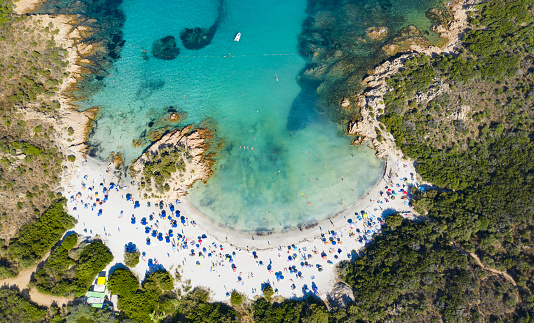 View from above, stunning aerial view of a beautiful beach bathed by a turquoise clear sea. Spiaggia del Principe, Costa Smeralda (Emerald Coast) Sardinia, Italy.