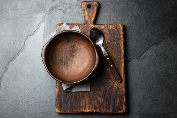 istock Cooking background. Vintage empty clay bowl on cutting boards, copy space 1161701329