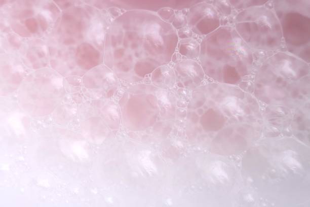 istock pink soap foam macro background.soap bubbles gently pink pastel color . Bath foam. Ease.Lightness and airiness 1161701357