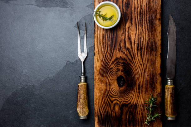 istock Cooking background concept. Vintage cutting board with cutlery. Top view 1161702482