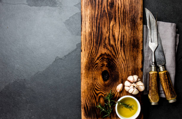 istock Cooking background concept. Vintage cutting board with cutlery. Top view 1161702484