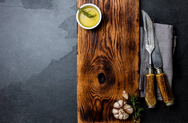 istock Cooking background concept. Vintage cutting board with cutlery. Top view 1161702485
