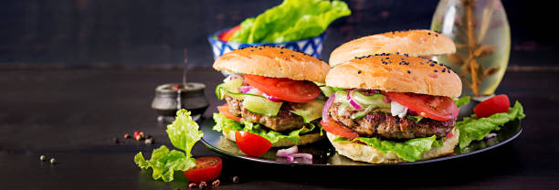 istock Big sandwich - hamburger burger with beef,  tomato,  red onion and lettuce. Banner 1161711198