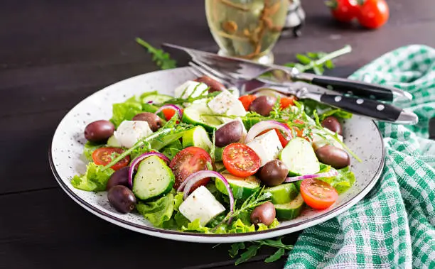 Photo of Greek salad with fresh vegetables, feta cheese and kalamata olives. Healthy food.
