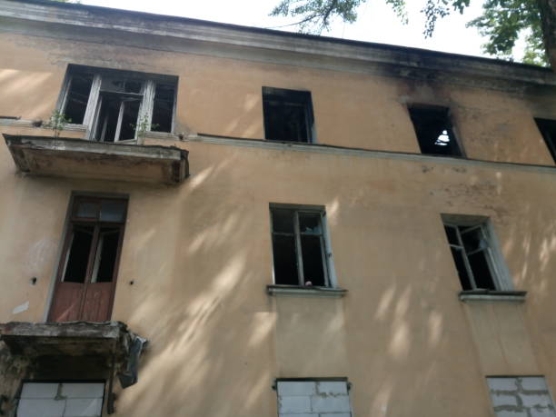 istock Burnt windows of an abandoned house 1161711813