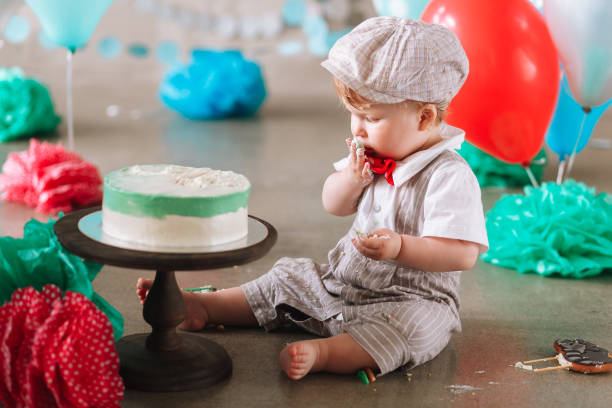 istock Baby boy touching his first birthday cake. Making messy cakesmash in decorated studio location 1161713302