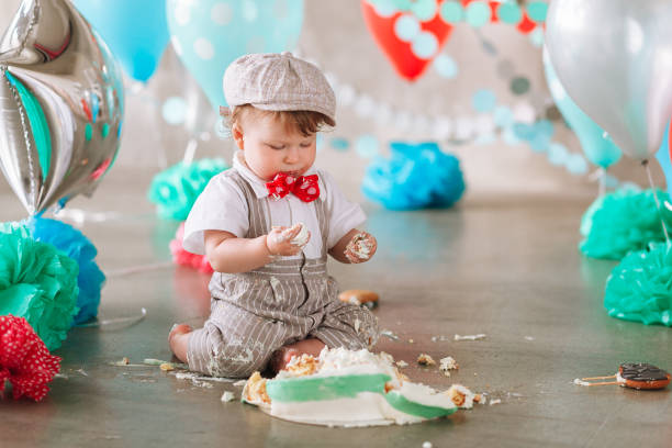 istock Baby boy touching his first birthday cake. Making messy cakesmash in decorated studio location 1161713323