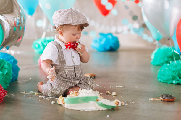 istock Baby boy touching his first birthday cake. Making messy cakesmash in decorated studio location 1161713328