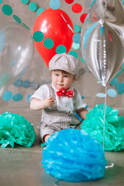 istock year-old boy in suit standing in decorated studio room looking up. Full-lenght vertical portrait 1161713338