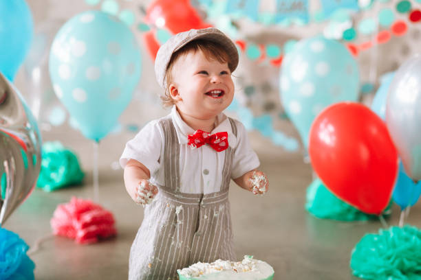 istock Baby boy touching his first birthday cake. Making messy cakesmash in decorated studio location 1161713428