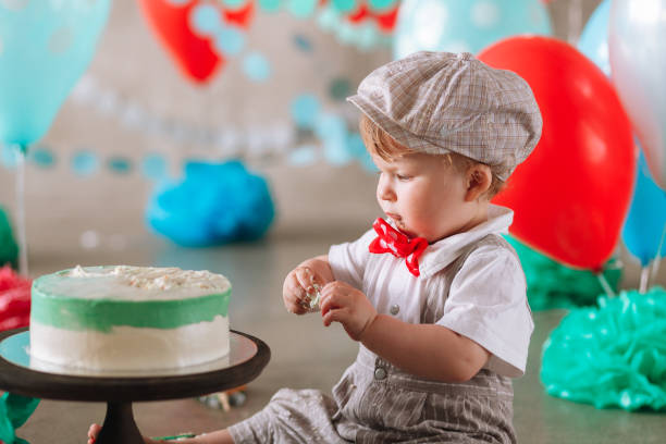 istock Baby boy touching his first birthday cake. Making messy cakesmash in decorated studio location 1161713439