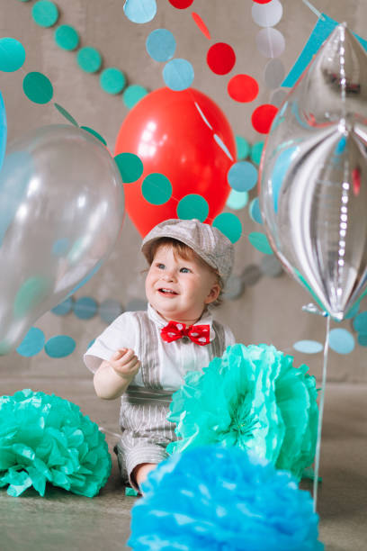 istock year-old boy in suit standing in decorated studio room looking up. Full-lenght vertical portrait 1161713462