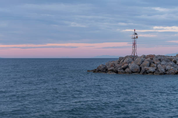 istock Mole or breakwater with lighthouse at a Greek Island harbor 1161716119