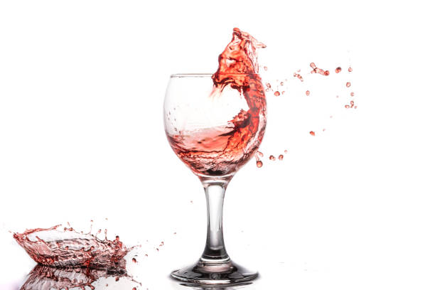istock Red wine splash in a round glass on a white background 1161717201