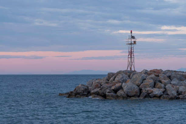 istock Mole or breakwater with lighthouse at a Greek Island harbor 1161717239
