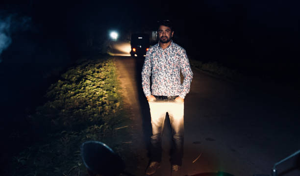 istock Man standing around a road at night 1161717364