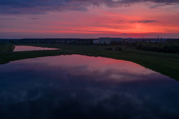 istock Crimson sunset in the sky over the lakes in the fields 1161718426