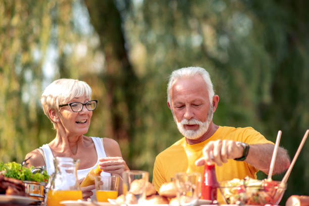 istock Senior couple having lunch in nature 1161719650