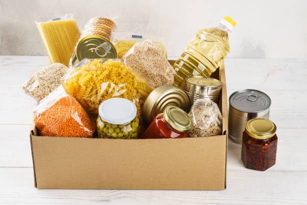 istock Various canned food, pasta and cereals in a cardboard box. 1161719773