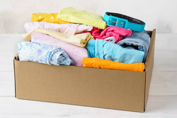 istock Various colorful clothes in a box for shipping or donation. 1161720514