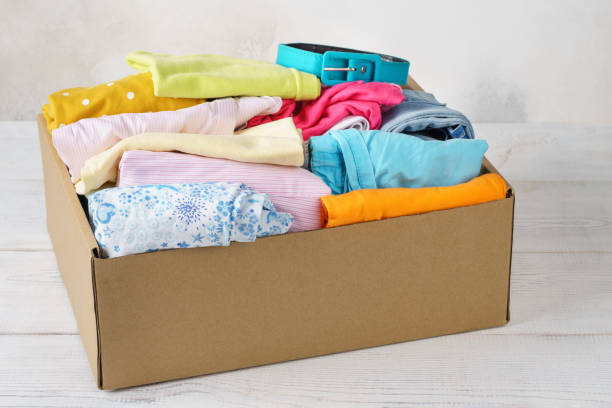 istock Various colorful clothes in a box for shipping or donation. 1161720552