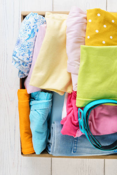 istock Various colorful clothes in a box for shipping or donation. 1161720727