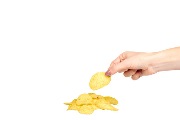 istock Hand with golden color potato chips, crunchy and wavy. 1161721801