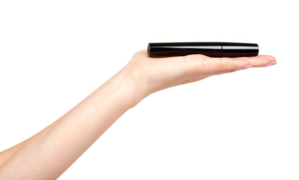 istock Hand with black mascara, eye makeup brush. 1161722450