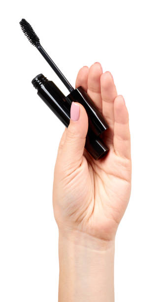 istock Hand with black mascara, eye makeup brush. 1161723254