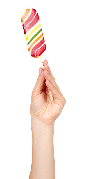 istock Hand with striped color lollipop, bright cool candy. 1161723638