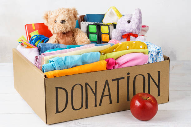 istock Different donations in a box - clothes, stationery and toys. 1161723655